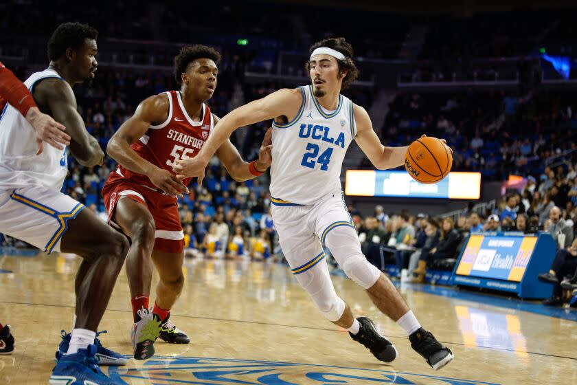 LOS ANGELES, CA - FEBRUARY 16: UCLA Bruins guard Jaime Jaquez Jr. (24) drives against Stanford Cardinal forward Harrison Ingram (55) as UCLA plays Stanford at Pauley Pavilion on Thursday, Feb. 16, 2023 in Los Angeles, CA. (Jason Armond / Los Angeles Times)