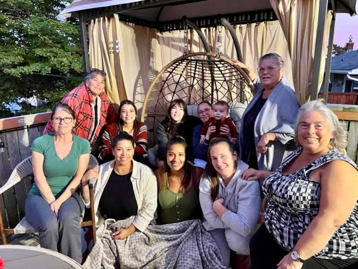 Kelsy Ellefsen is seen in the front row, second from the right. She's joined by her mom, aunts and cousins, many of whom live in Dartmouth, N.S. (Submitted by Kelsy Ellefsen - image credit)