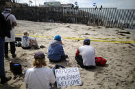 <p>Supporters sit on the U.S. side of the U.S.-Mexico border wall at Border Field State Park as members of a migrant caravan from Central America stand on the other side, in San Diego, California, April 29, 2018. (Photo: Lucy Nicholson/Reuters) </p>