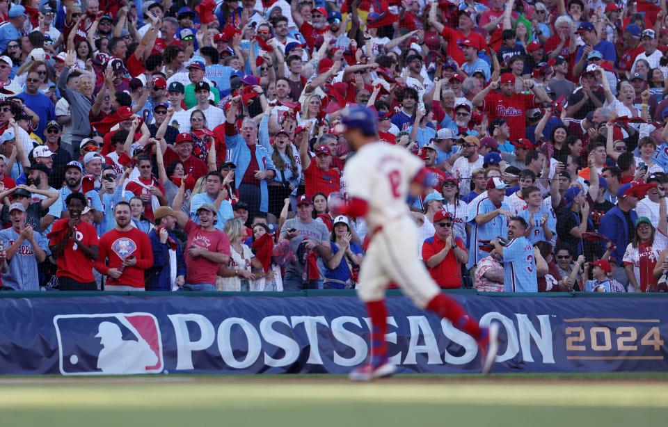 Philadelphia Phillies fans celebrate a solo home run by designated hitter Kyle Schwarber