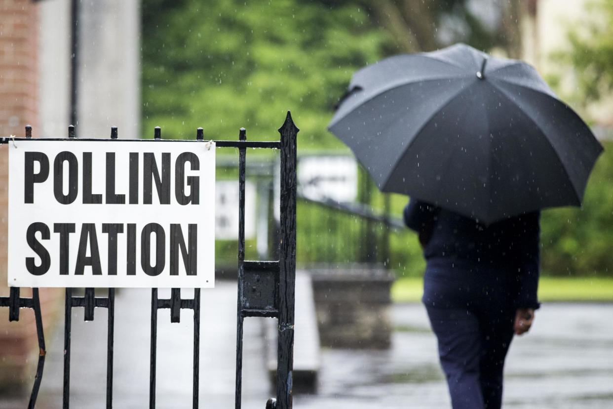 A voter arrives at the polling station in St Nicolas Parish Hall, Belfast: PA Archive/PA Images