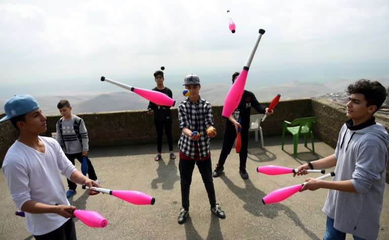 Young Syrian refugees learn to juggle on a rooftop of a house in Mardin, south-eastern Turkey