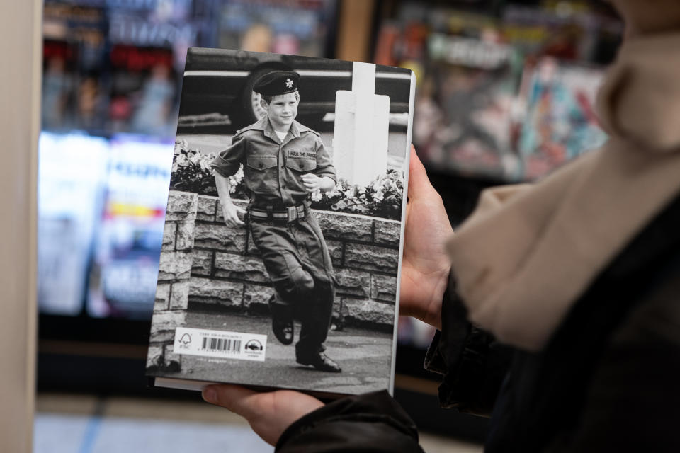 The back feature image of Prince Harry runs towards a light tank during a visit to the barracks of the Light Dragoons in Hannover, Germany July 29, 1993 as the newly released autobiography from the Duke of Sussex at WHSmith's in Victoria Station, the book became available to purchase at midnight. Picture date: Tuesday January 10, 2023. (Photo by Aaron Chown/PA Images via Getty Images)