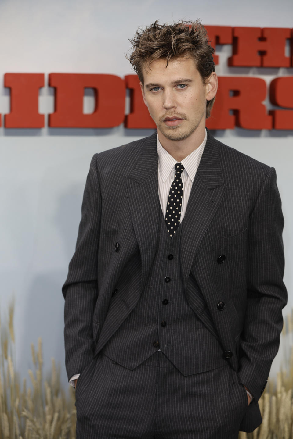 Austin Butler attends an event in a pinstripe suit with a polka-dot tie