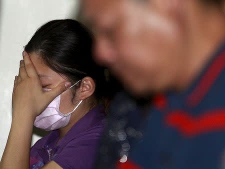 A family member of a victim injured in a fire at the Formosa Fun Coast water park reacts at Taipei Veterans General Hospital in Taipei, Taiwan, June 28, 2015. REUTERS/Pichi Chuang