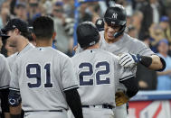 New York Yankees' Aaron Judge, right, is congratulated by teammates, including Harrison Bader (22), for his 61st home run of the season, against the Toronto Blue Jays during the seventh inning of a baseball game Wednesday, Sept. 28, 2022, in Toronto. (Nathan Denette/The Canadian Press via AP)