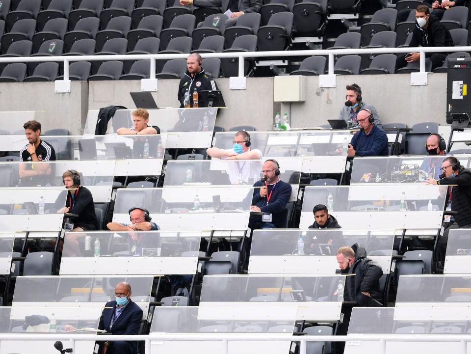 Journalists watch on from a press box (POOL/AFP via Getty Images)