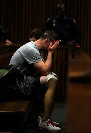 FILE PHOTO Paralympic gold medalist Oscar Pistorius, seen with his prosthetic legs, reacts during the third day of the re-sentencing hearing for the 2013 murder of his girlfriend Reeva Steenkamp, at Pretoria High Court, South Africa June 15, 2016. REUTERS/Siphiwe Sibeko/File Photo