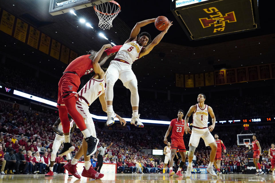Iowa State guard Lindell Wigginton (5) grabs a rebound over Texas Tech center Norense Odiase, left, during the first half of an NCAA college basketball game, Saturday, March 9, 2019, in Ames, Iowa. (AP Photo/Charlie Neibergall)