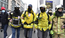 Demonstrators march during a protest against coronavirus measures in Brussels, Belgium, Sunday, Dec. 5, 2021. Hundreds of people marched through central Brussels on Sunday to protest tightened COVID-19 restrictions imposed by the Belgian government to counter the latest spike in coronavirus cases. (AP Photo/Geert Vanden Wijngaert)