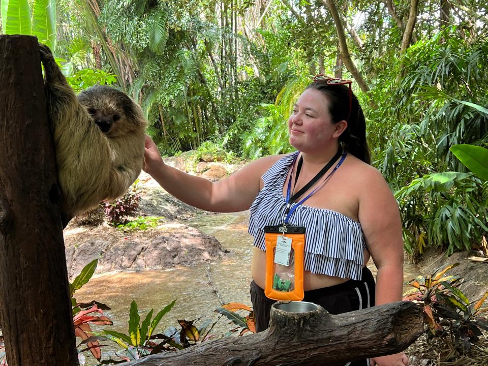 megan petting a sloth at discovery cove in orlando