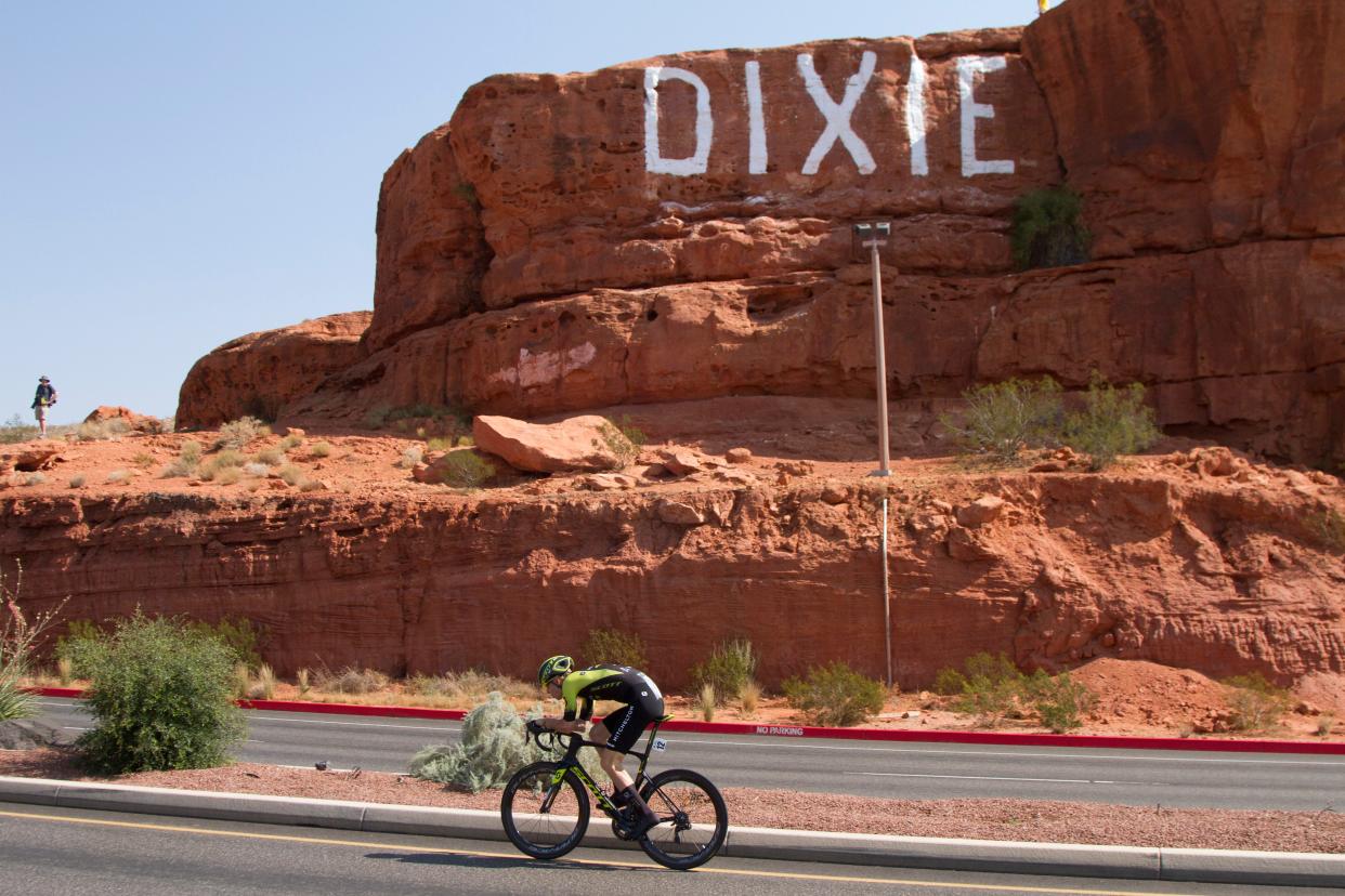 A cyclist rides past the "Sugarloaf" rock in St. George.