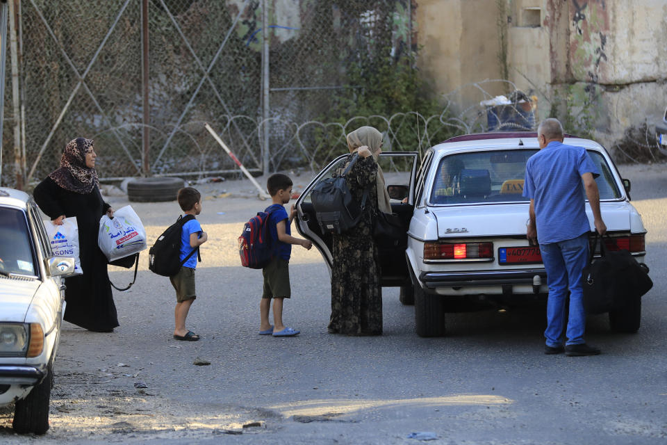 Palestinian residents flee their home after clashes that erupted between members of the Palestinian Fatah group and Islamist militants in the Palestinian refugee camp of Ein el-Hilweh near the southern port city of Sidon, Friday, Sept. 8, 2023. Clashes resumed in Lebanon's largest Palestinian camp overnight, with heavy gunfire and shelling wounding several people and prompting residents of the camp and the surrounding area to flee Friday. (AP Photo/Mohammed Zaatari)