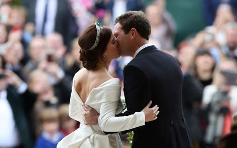 The newlyweds kiss on the steps as Royal family gains its newest member - Credit: PA