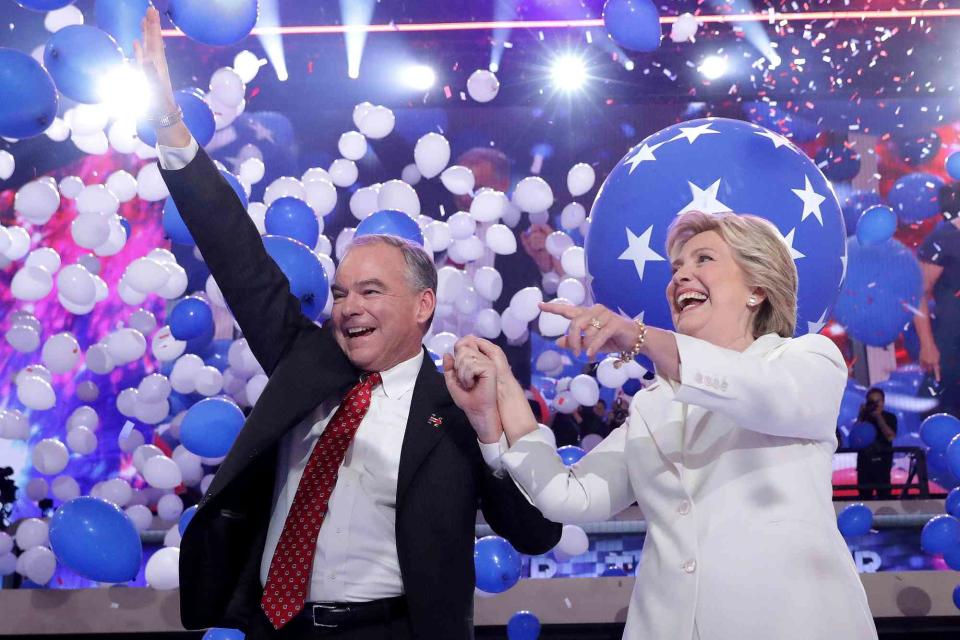 <p>Chip Somodevilla/Getty</p> VP nominee Tim Kaine waves to voters alongside presidential candidate Hillary Clinton at the 2016 Democratic National Convention