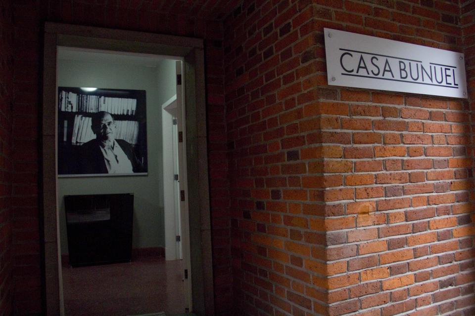 In this Aug. 1, 2013 photo, a photograph of Spanish filmmaker Luis Bunuel hangs at the entrance of "Casa Bunuel" in Mexico City. The Spanish government has opened this house after restoring the facade and conditioning the interiors. Now, the Spanish government, which bought the house from Bunuel’s family, has opened the house to a public long fascinated with his work. (AP Photo/Gabriela Sanchez)