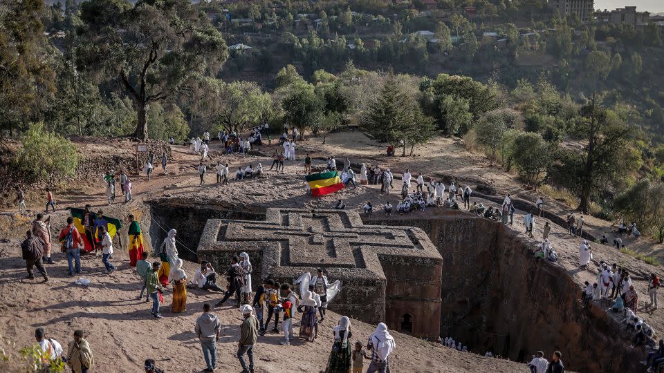Ethiopian Orthodox worshippers gather next to a rock-hewn church in Lalibela, a UNESCO World Heritage Site, on January 7, 2024. - Michele Spatari/AFP/Getty Images