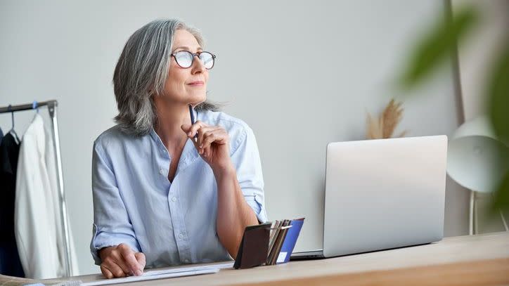 A woman considers her retirement plans while also reviewing her future Social Security benefits. 