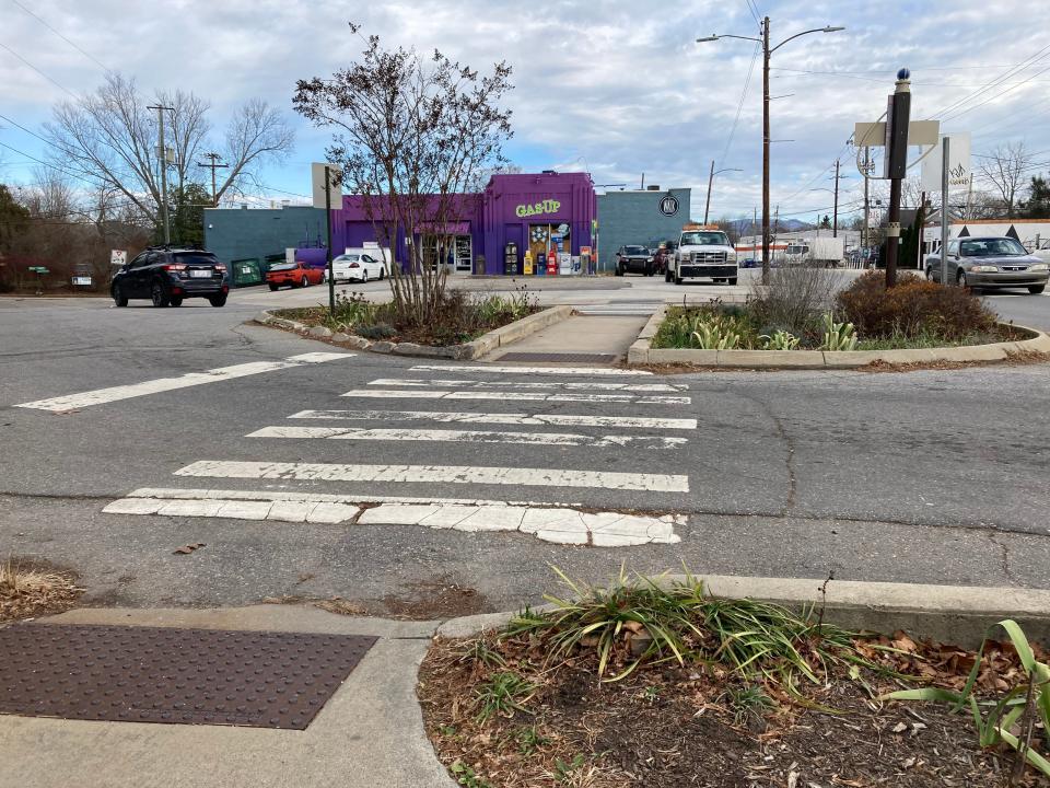 Part of its proposed resurfacing project, the NCDOT invites public input on improvements for Haywood Road. A faded crosswalk delineates the intersection of Haywood Road and Westwood Place.