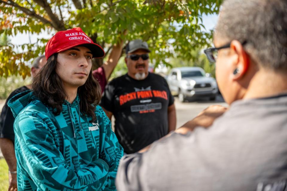 A counter demonstrator listens to an attendee during a protest against the reinstallation of a 16th-century New Mexico conquistador statue at the Rio Arriba County building on September 28, 2023 in Espanola, New Mexico (Getty Images)