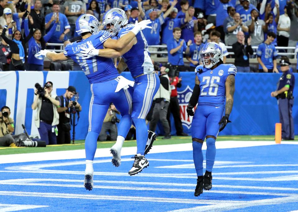 Detroit Lions tight ends Sam LaPorta (87), Brock Wright (89) and running back Jahmyr Gibbs (26) celebrate LaPorta's touchdown during first-half action vs. the Atlanta Falcons at Ford Field in Detroit on Sunday, Sept. 24, 2023.