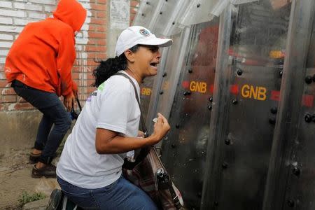 Demonstrator reacts against riot security forces during the 'march of the empty pots' against Venezuelan President Nicolas Maduro's government in Caracas, Venezuela, June 3, 2017. REUTERS/Marco Bello