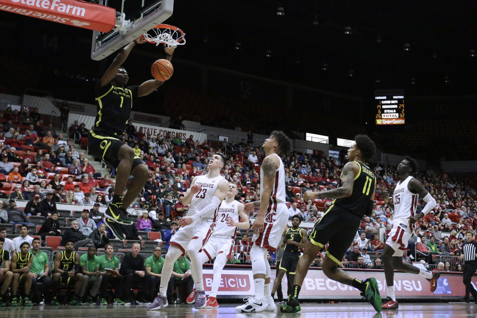 Oregon center N'Faly Dante (1) dunks during the second half of the team's NCAA college basketball game against Washington State, Sunday, Feb. 19, 2023, in Pullman, Wash. Washington State won 68-65. (AP Photo/Young Kwak)