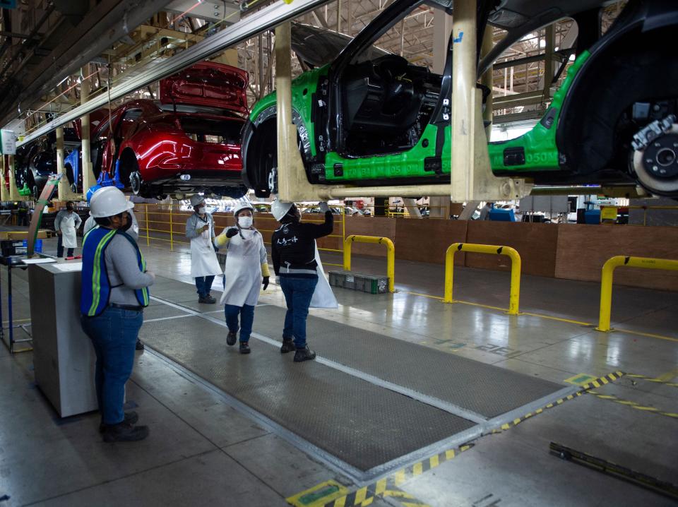Employees work on a car production line at Mazda's plant in Salamanca, Guanajuato state, Mexico, on November 9, 2022.