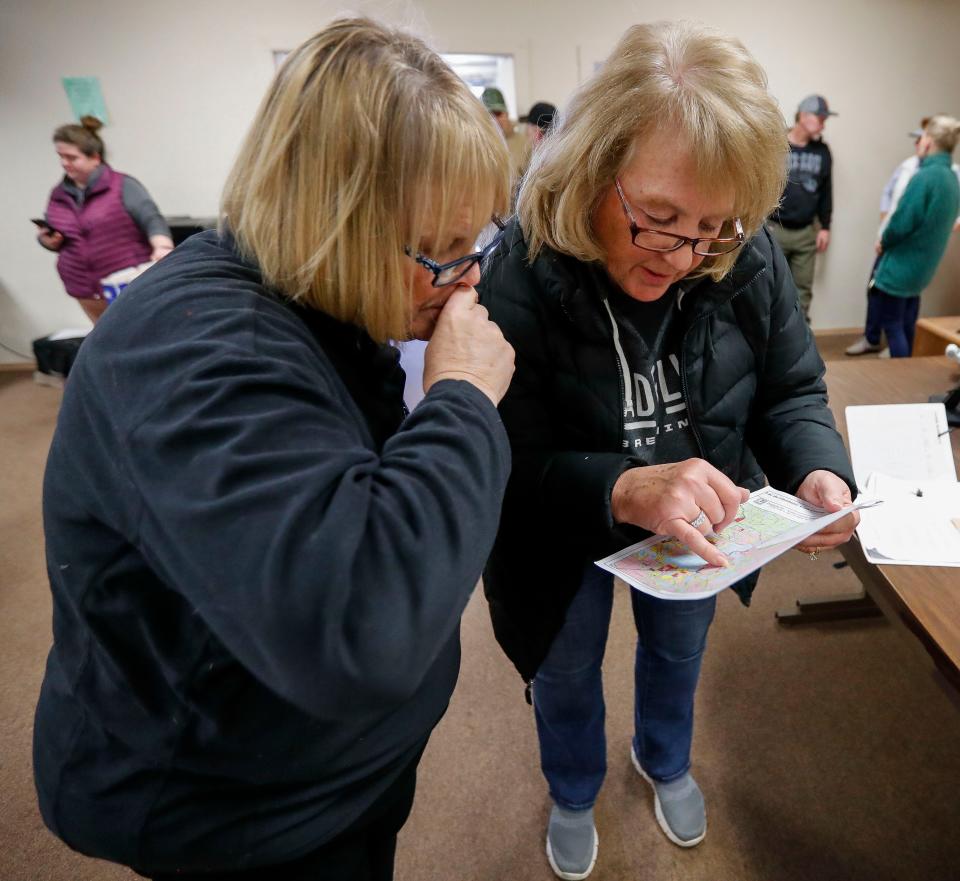 Residents Holly Schwartz (left) and Cindy Lee (right) review a local road map on Wednesday, February 8, 2023, at Lac du Flambeau town hall in Lac du Flambeau, Wis. A special town board meeting was held to receive public comment and deliberate over the town’s course of action in response to Lac du Flambeau reservation tribal officials erecting barricades along four roads in the area. Tribal officials set up barricades on the roads Jan. 30 after negotiations with property title companies that built the roads and the homes they access broke down. Tribal officials say the roads were illegally built on tribal lands and the tribe was not compensated for the right-of-way easements.Tork Mason/USA TODAY NETWORK-Wisconsin 