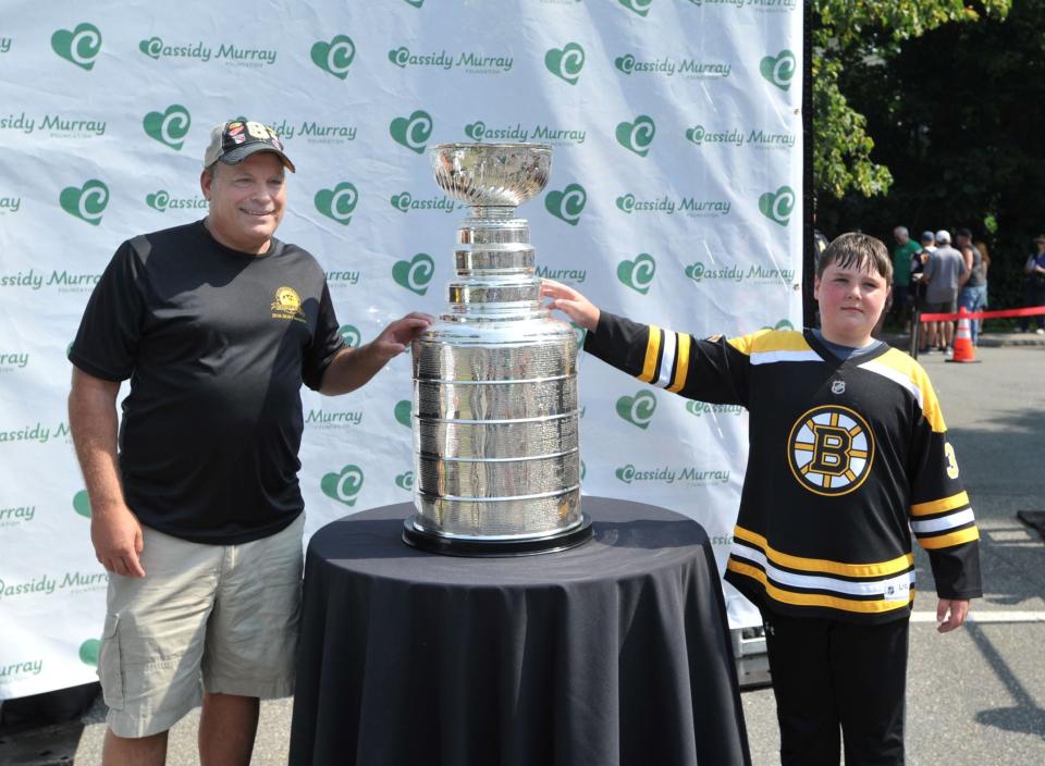 Stephen Forcillo, of Dorchester, left, and Jack Boehler, 13, of Milton, pose with the Stanley Cup during the kickoff of the Cassidy Murray Foundation in Milton on Thursday, July 13, 2023.