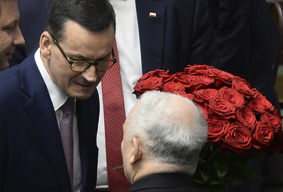 Polish Prime Minister Mateusz Morawiecki, left, speaks with ruling party Law and Justice leader Jaroslaw Kaczynski, after winning the confidence vote in the parliament, in Warsaw, Poland, Wednesday, Dec. 12, 2018. Morawiecki’s conservative government easily survived a confidence vote in parliament that the leader had unexpectedly asked for earlier in the day. Morawiecki, with the ruling Law and Justice party, had said he wanted to reconfirm that his government has a mandate from lawmakers as it pushes through its “great reforms.”(AP Photo/Alik Keplicz)