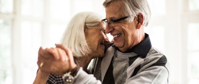 Senior couple dancing in living room