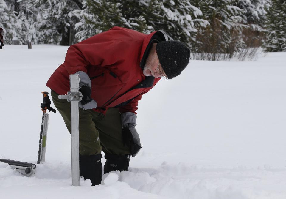 Frank Gehrke, chief of the California Cooperative Snow Surveys Program for the Department of Water Resources, checks the snowpack depth as he conducts the first snow survey of the season at Phillips Station Tuesday, Jan. 3, 2017, in Echo Summit, Calif. The survey showed the snowpack at 53 percent of normal for this site at this time of year. (AP Photo/Rich Pedroncelli)