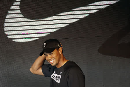 FILE PHOTO: U.S. golfer Tiger Woods gestures as he meet students of Beijing Sports University in Beijing April 13, 2011. REUTERS/Petar Kujundzic