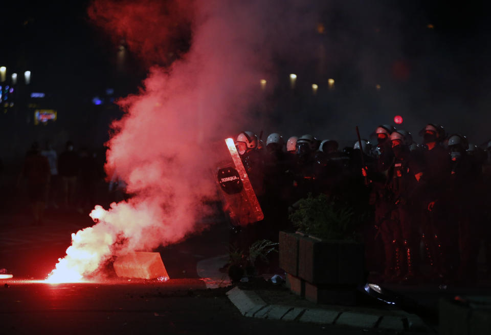 Serbian police officers guard the parliament building in Belgrade, Serbia, Tuesday, July 7, 2020. Thousands of people protested the Serbian president's announcement that a lockdown will be reintroduced after the Balkan country reported its highest single-day death toll from the coronavirus Tuesday. (AP Photo/Darko Vojinovic)