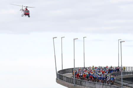 Cycling - UCI Road World Championships - Men Elite Road Race - Bergen, Norway - September 24, 2017 – Competitors cross a bridge while helicopter flies over the pelothon. NTB Scanpix/Cornelius Poppe via REUTERS