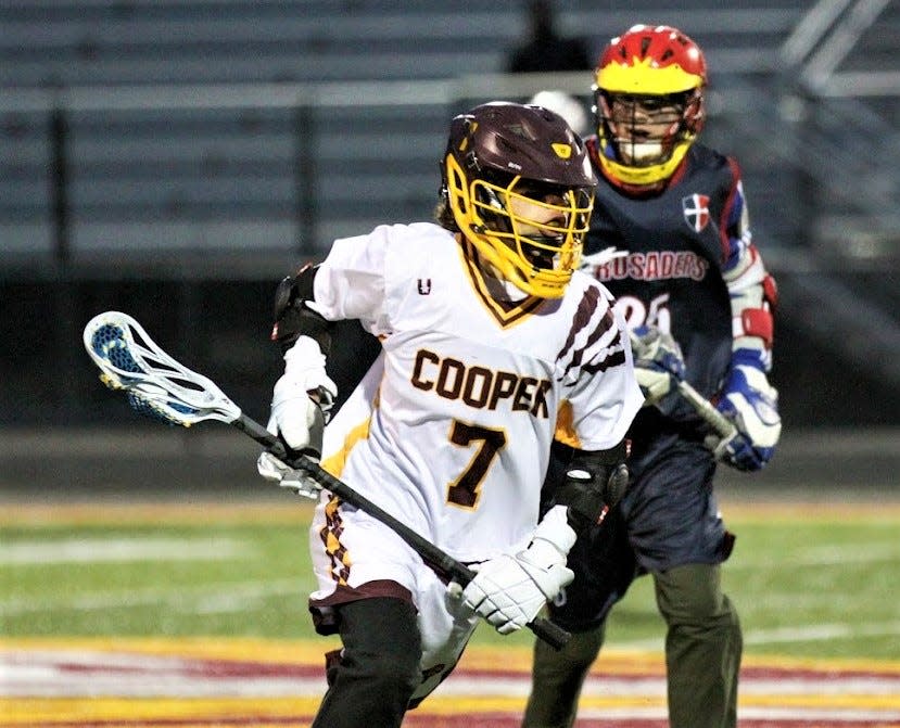 Cooper freshman Lawson White advances during Cooper's first-ever win in lacrosse, over St. Henry, March 10, 2023.