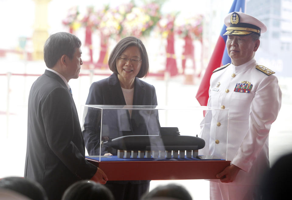 Taiwan's President Tsai Ing-wen, center, looks at the first indigenous submarine model during a groundbreaking ceremony for the island's naval submarine factory in Kaohsiung, southern Taiwan, Thursday, May 9, 2019. (AP Photo/Chiang Ying-ying)