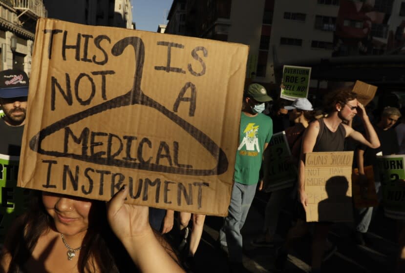 LOS ANGELES, CA - JUNE 24, 2022 - - Hundreds of activists march through the streets of downtown Los Angeles to protest the Supreme Court's conservative majority decision to overturn Roe v. Wade and ending constitutional protections for abortion that had been in place nearly 50 years on June 24, 2022. (Genaro Molina / Los Angeles Times)