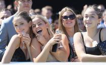 <p>Racegoers take in the view trackside.</p>