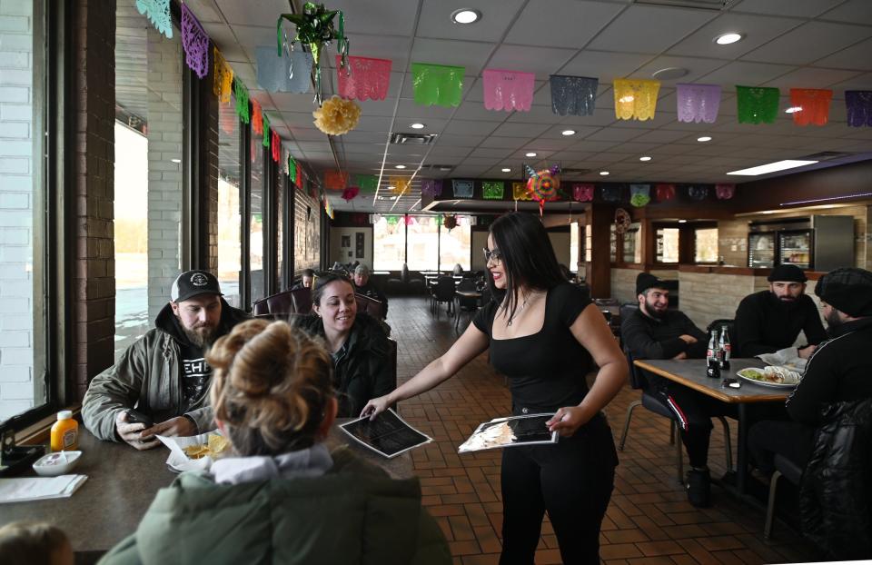 Amy Garcia greets diners Tuesday, Nov. 28, 2023, at El Molino Mexican Restaurant on Lansing Road in Dimondale. The restaurant's namesake was inspired by the greater Lansing landmark Don's Windmill Truckstop and restaurant. "El Molino" translated from Spanish to English means "The Windmill."