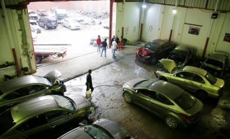 Employees work on new arrival of cars at the workshop of El Faqyier (The Poor), a crash-damaged vehicles and second-hand car shop, in Cairo, Egypt November 14, 2017. Picture taken November 14, 2017. REUTERS/Amr Abdallah Dalsh