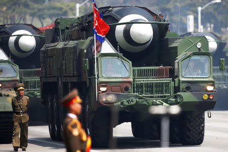 FILE PHOTO: Missiles are driven past the stand with North Korean leader Kim Jong Un and other high ranking officials during a military parade marking the 105th birth anniversary of the country's founding father, Kim Il Sung in Pyongyang, April 15, 2017. REUTERS/Damir Sagolj/File Photo