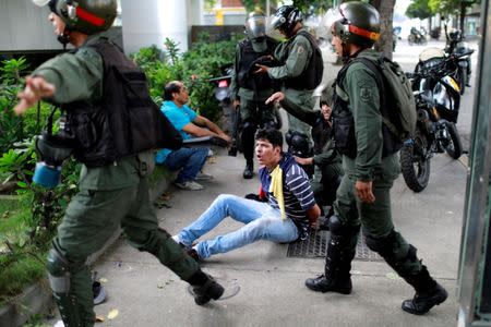 FILE PHOTO: A demonstrator is detained at a rally during a strike called to protest against Venezuelan President Nicolas Maduro's government in Caracas, Venezuela, July 27, 2017 . REUTERS/Marco Bello/File Photo