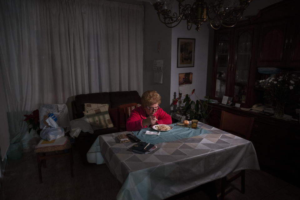 Rosa Otero, 83, eats her Christmas Eve dinner at her home in Barcelona, Spain, Thursday, Dec. 24, 2020. Otero normally travels cross Spain to spend Christmas with family. But health restrictions have made that impossible this year for the 83-year-old widow. She is one of many of Spain's elderly who are feeling even more alone than ever this Christmas Eve. (AP Photo/Emilio Morenatti)