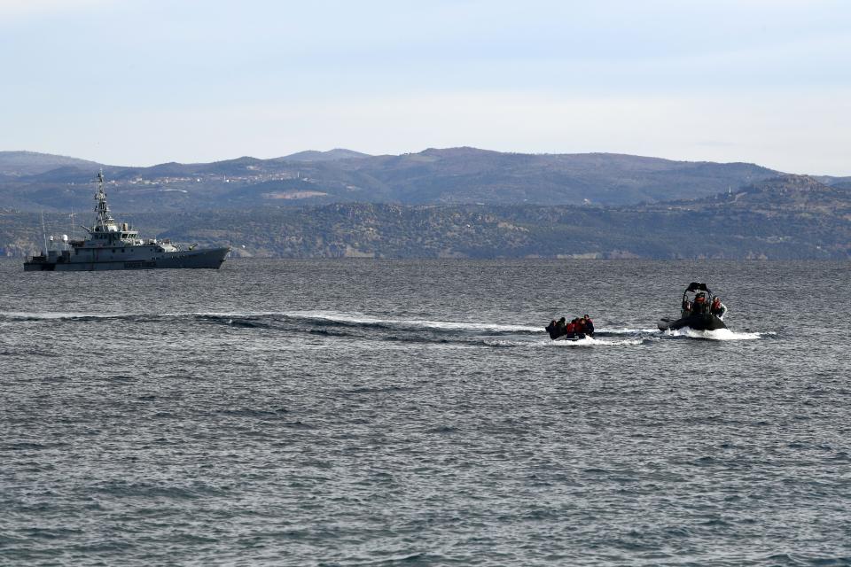 Refugees and migrants arrive with a dinghy accompanied by Frontex vessels at the village of Skala Sikaminias, on the Greek island of Lesbos, after crossing the Aegean sea from Turkey, on Friday, Feb. 28, 2020. An air strike by Syrian government forces killed scores of Turkish soldiers in northeast Syria, a Turkish official said Friday, marking the largest death toll for Turkey in a single day since it first intervened in Syria in 2016. (AP Photo/Micheal Varaklas)