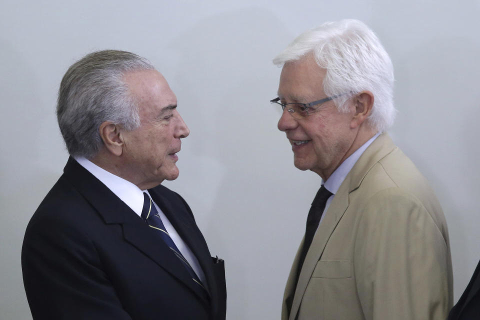 FILE - In this May 12, 2017 file photo, Brazil's President Michel Temer and Minister of Mines and Energy Moreira Franco, attend a ceremony at the Planalto Presidential Palace, in Brasilia, Brazil. A judge in Rio de Janeiro issued an arrest warrant Thursday, March 21, 2019, for the former president and Franco, who are being investigated in several corruption cases. (AP Photo/Eraldo Peres, File)