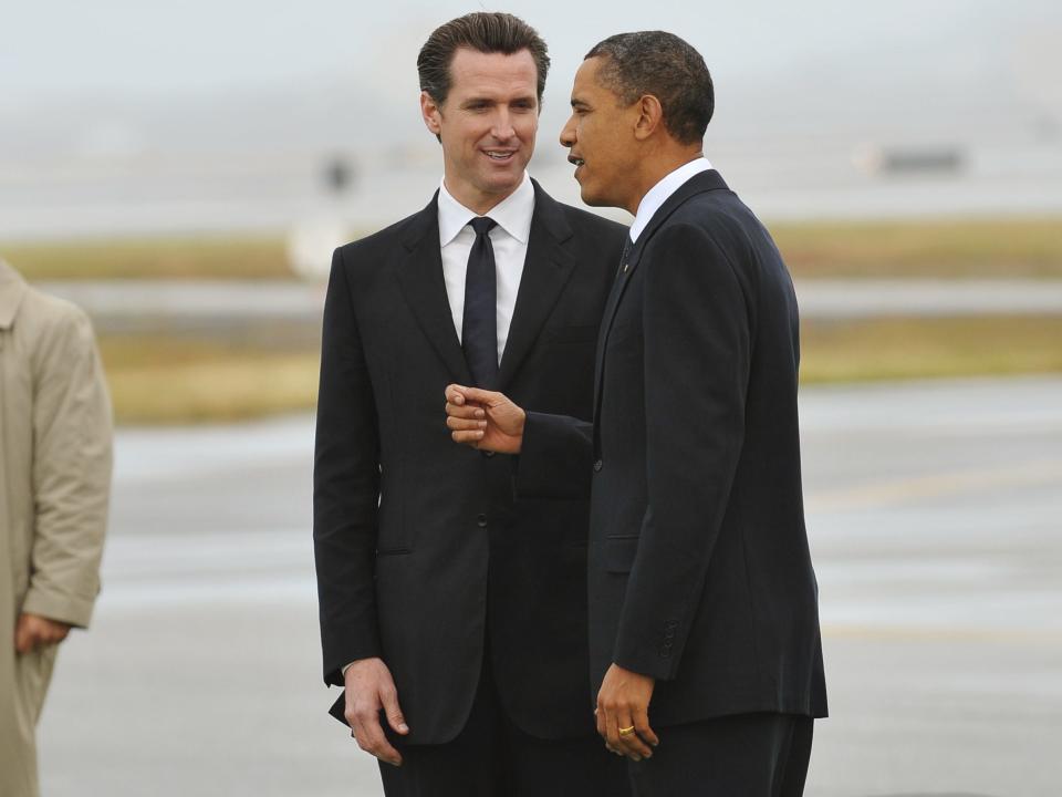 US President Barack Obama chats with San Francisco Mayor Gavin Newsom after stepping off Air Force One.