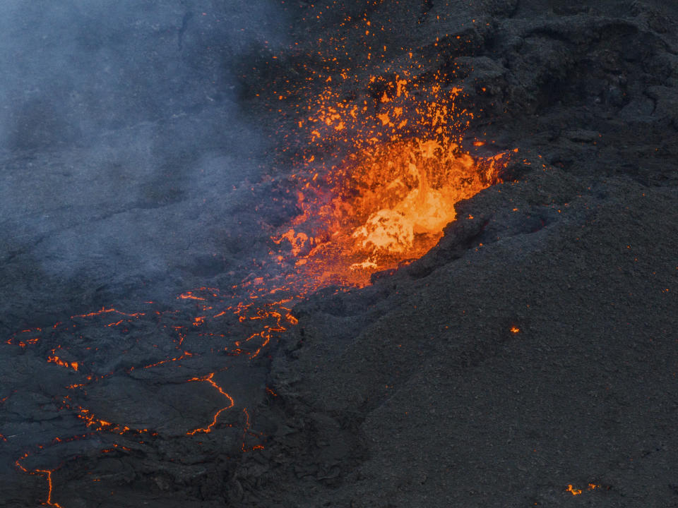 Lava flows from the Fagradalsfjall volcano, north of Grindavik, Iceland, Monday, Jan. 15, 2024. Iceland's president says the country is battling "tremendous forces of nature" after molten lava from a volcano consumed several houses in the evacuated town of Grindavik. (AP Photo/ Marco Di Marco)