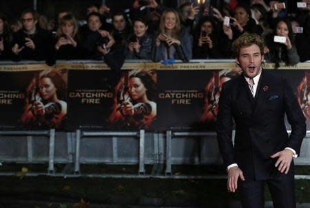 Actor Sam Claflin reacts as he arrives for the world premiere of "The Hunger Games : Catching Fire" at Leicester Square in London November 11, 2013. REUTERS/Luke MacGregor